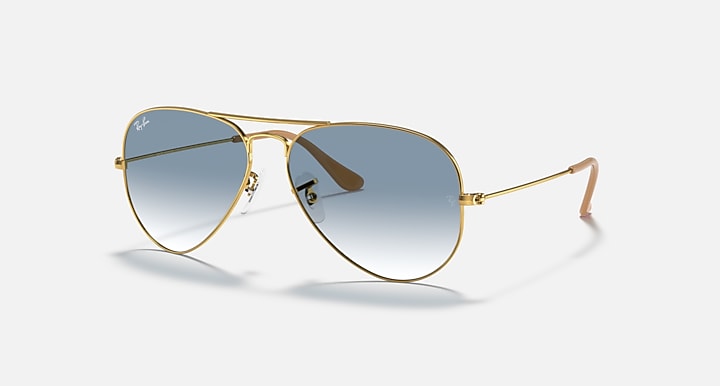 Ray-Ban aviator sunglasses with gold frame and mirrored blue-gray lenses, side view