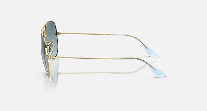 Gold metal aviator sunglasses with light lenses and pale blue temple tips