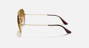 Gold metal aviator sunglasses with brown-tinted lenses and curved arms
