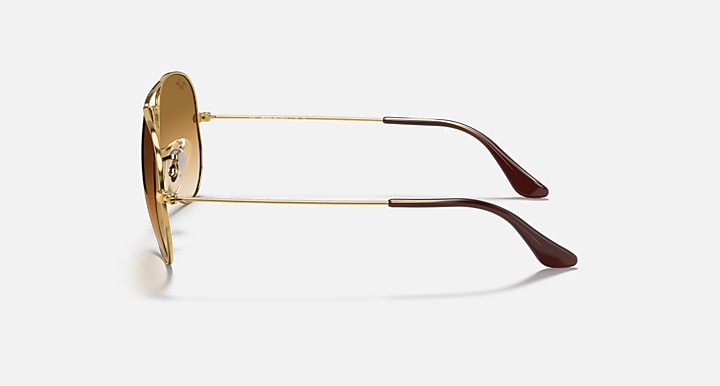 Gold metal aviator sunglasses with brown-tinted lenses and curved arms