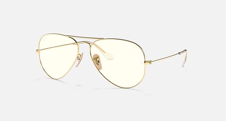 Ray-Ban aviator sunglasses with light gold frame and clear lenses