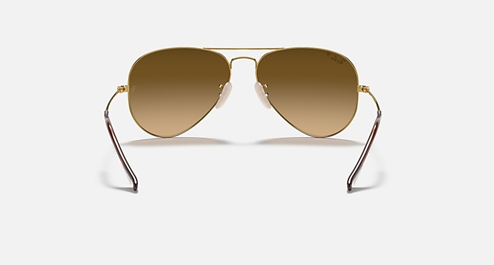 Ray-Ban aviator sunglasses with thin metal frame and amber brown tinted lenses.