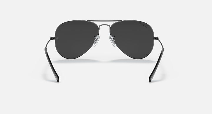 Ray-Ban aviator sunglasses with thin metal frame and dark charcoal tinted lenses.