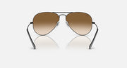 Ray-Ban aviator sunglasses with thin metal frame and warm brown tinted lenses.