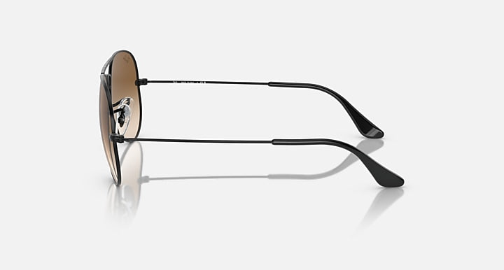 Ray-Ban aviator sunglasses in profile: green lens, silver frame, black temples