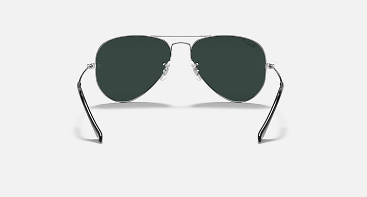 Ray-Ban aviator sunglasses with thin metal frame and deep green tinted lenses.