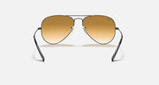 Ray-Ban aviator sunglasses with gold frame and amber lenses, front view