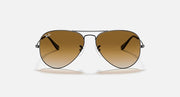 Gold-tone aviator sunglasses with brown gradient lenses and metal frame