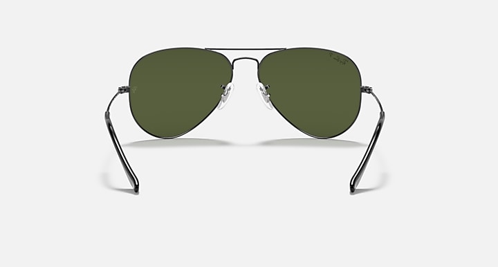 Ray-Ban aviator sunglasses with thin metal frame and olive green tinted lenses.