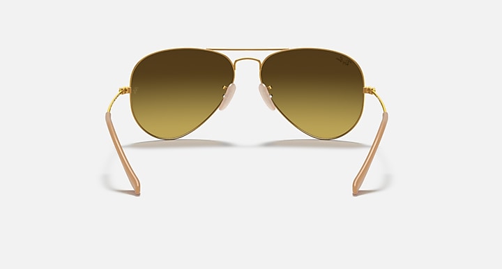 Ray-Ban aviator sunglasses with warm brown lenses and gold metal frame