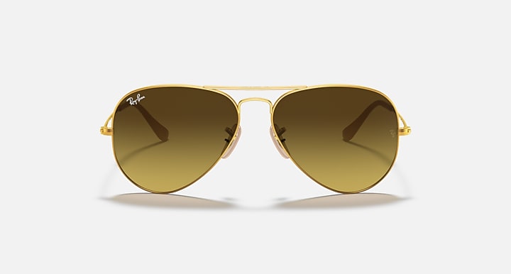 Gold aviator sunglasses with warm brown tinted lenses and metal bridge
