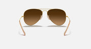Ray-Ban aviator sunglasses with amber-brown lenses and gold metal frame