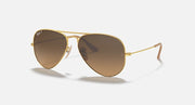 Gold aviator sunglasses with dark brown lenses and thin metal frame arms