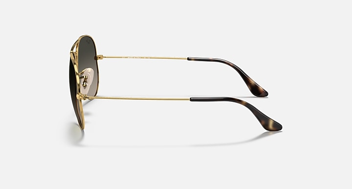 Ray-Ban aviator sunglasses with gold metal frame and dark lenses with dark tips