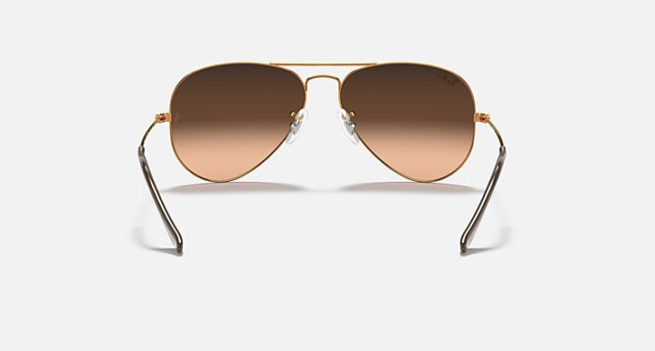 Aviator sunglasses with gold frame and brown gradient lenses