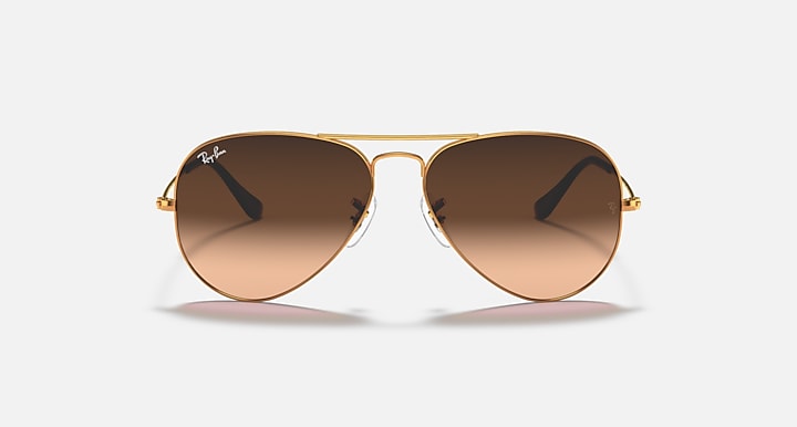 Gold aviator sunglasses with brown tinted lenses and metal bridge