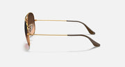 Ray-Ban aviator sunglasses with gold metal frame and dark lenses with brown tips