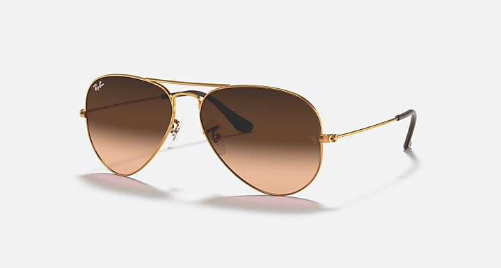 Gold aviator sunglasses with brown lenses and thin metal frame arms