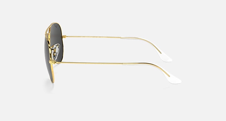 Gold metal aviator sunglasses with dark lenses and white/metal temple tips