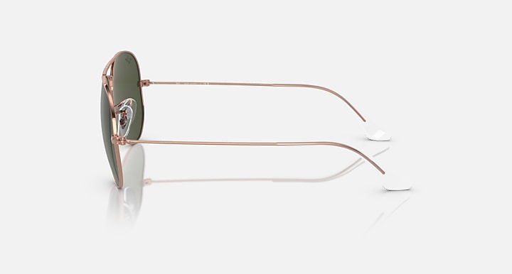 Aviator sunglasses, left side profile, rose-gold metal frame and dark lenses