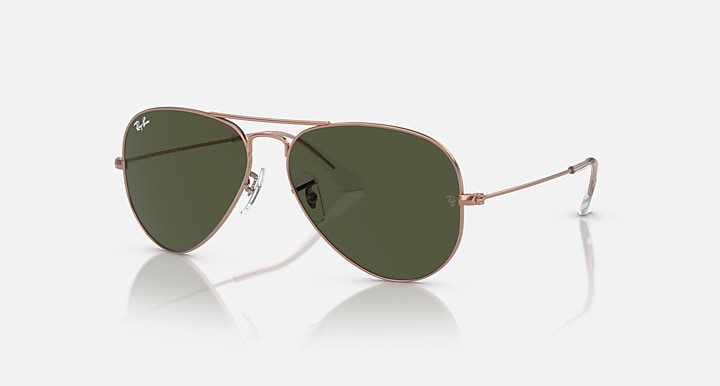 Rose gold aviator sunglasses with dark green lenses and thin metal frame arms