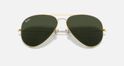 Ray-Ban aviator sunglasses with gold metal frame and dark green lenses, centered view