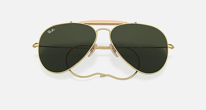 Gold frame aviator sunglasses with dark green lenses, close-up front view