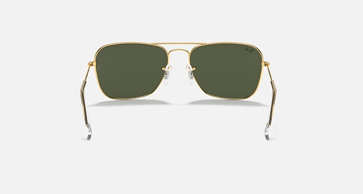 Ray-Ban Caravan sunglasses front view with dark green lenses and slim gold arms