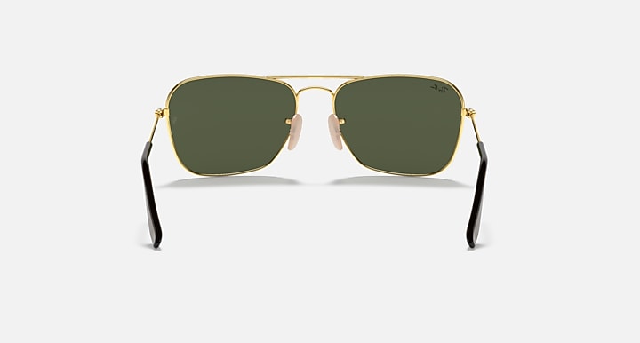 Gold-framed sunglasses with dark green lenses and black nose pads