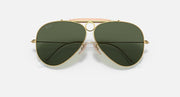 Ray-Ban aviator sunglasses with large dark green lenses, gold frame and pink center