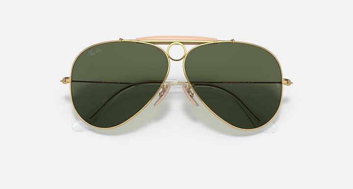 Ray-Ban aviator sunglasses with large dark green lenses, gold frame and pink center