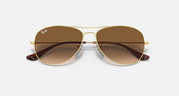 Aviator sunglasses with gold frame and brown gradient lenses, front close view