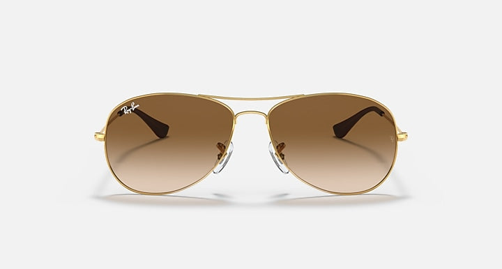 Aviator sunglasses with gold wire frame and gradient brown lenses, front view