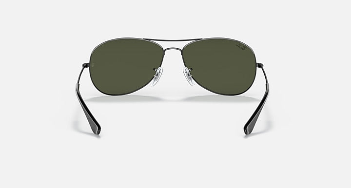 Gunmetal oval sunglasses with green lenses and curved rim detailing