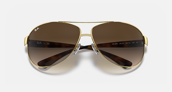 Ray-Ban aviator sunglasses with gold-tone frame and brown gradient lenses
