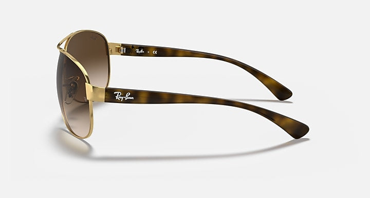 Aviator sunglasses with gold frame, brown lenses, and tortoiseshell temples