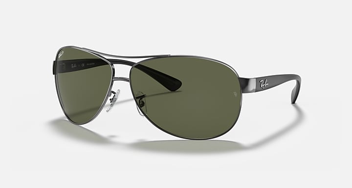 Ray-Ban aviator sunglasses with green lenses and silver metal frame, side angle.