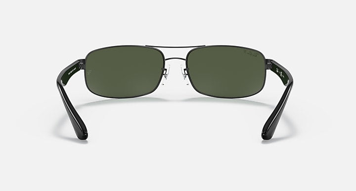 Front view sunglasses with black frame and olive-green tinted lenses