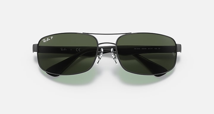 Sunglasses with black frame and reflective dark green lenses