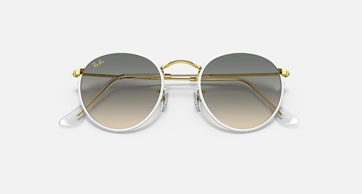Round sunglasses with gold-and-silver frame, gray tinted lenses.