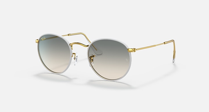 Round sunglasses with gold metal frame and dark gray tinted lenses.
