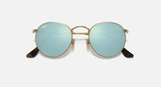 Round Ray-Ban sunglasses with gold frame, light-blue gradient lenses, black temple tips