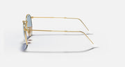 Gold-tone metal sunglasses with clear lens edge, side profile