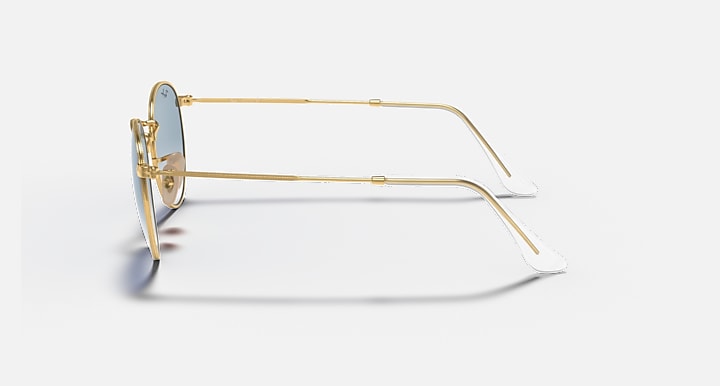 Gold-tone metal sunglasses with clear lens edge, side profile