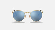 Round Ray-Ban sunglasses with gold frame, teal gradient lenses, curved bridge