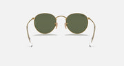 Ray-Ban RB3447N round sunglasses with gold frames and deep green tinted lenses
