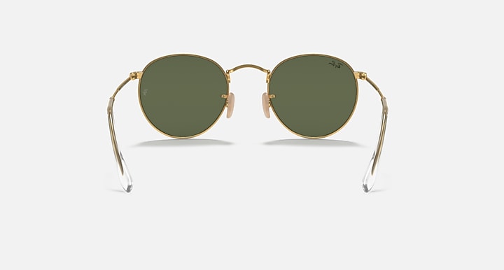 Ray-Ban RB3447N round sunglasses with gold frames and deep green tinted lenses