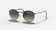 Black round sunglasses with dark lenses, metal frame, side angle