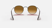 Ray-Ban RB3447N round sunglasses with silver frame and amber-brown lenses
