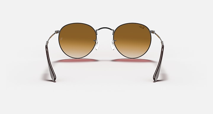 Ray-Ban RB3447N round sunglasses with silver frame and amber-brown lenses